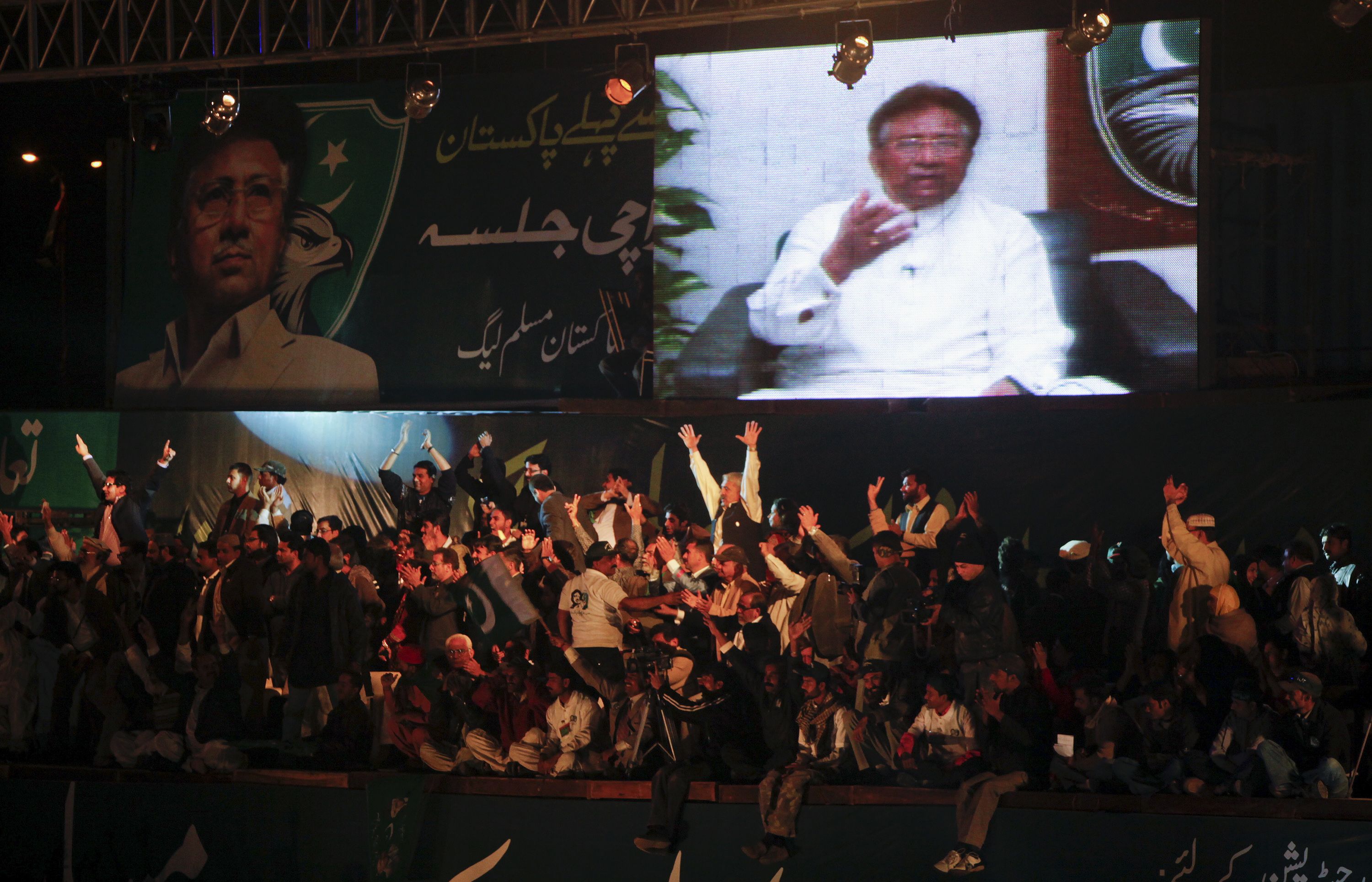 Supporters of the All Pakistan Muslim League, a political party founded by Musharraf, watch him give a speech from Dubai in January 2012.