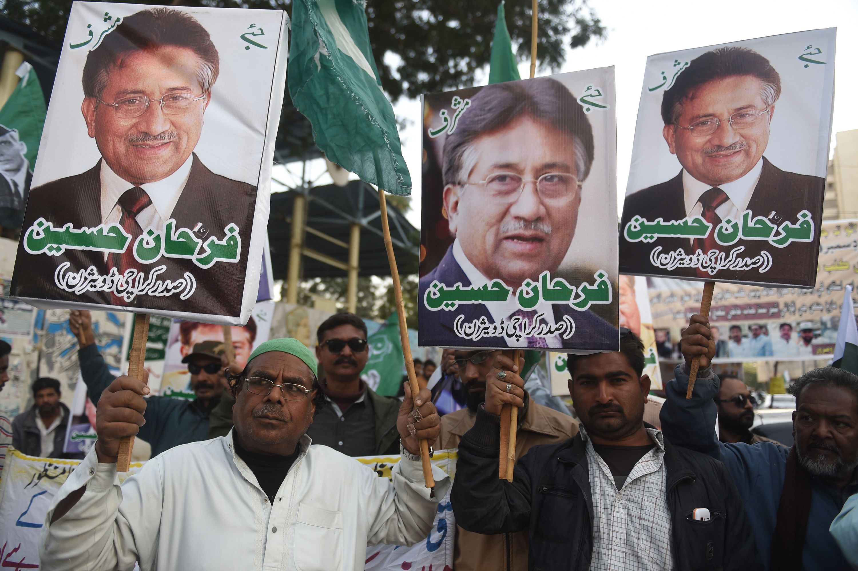 Musharraf supporters carry placards during a protest in Karachi following a special court's verdict in December 2019.