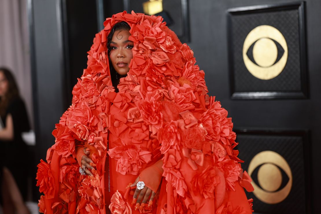 Lizzo wore a dramatic Dolce & Gabbana cape with floral appliques from the label's Alta Moda 2022 collection. 