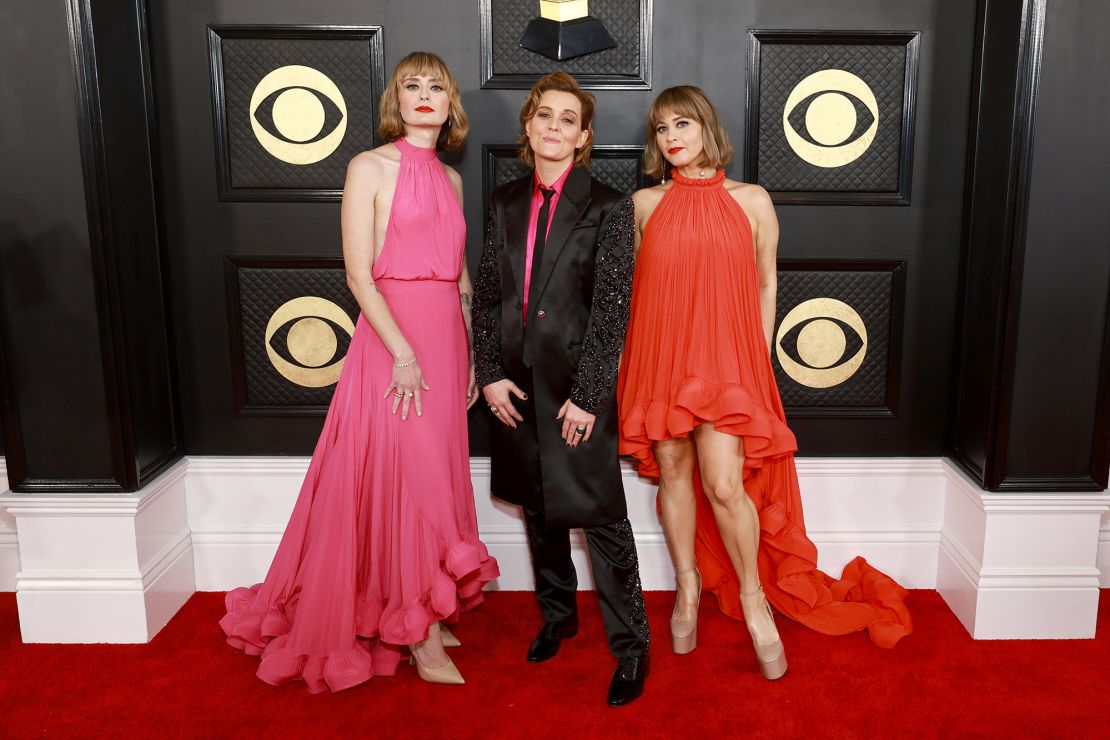 Singer-songwriter Brandi Carlile (center), wearing Versace, poses alongside Holly Laessig and Jess Wolfe of Lucius.