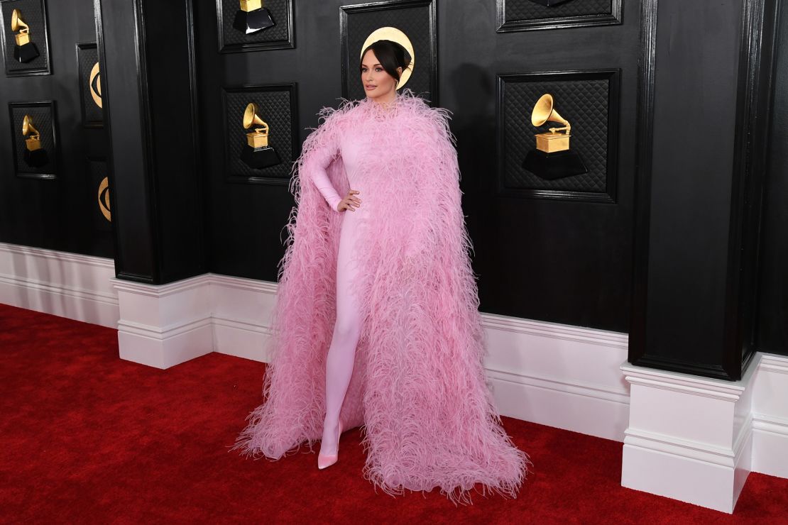 Kacey Musgraves wore a pink bodysuit and feathered cape by Valentino.