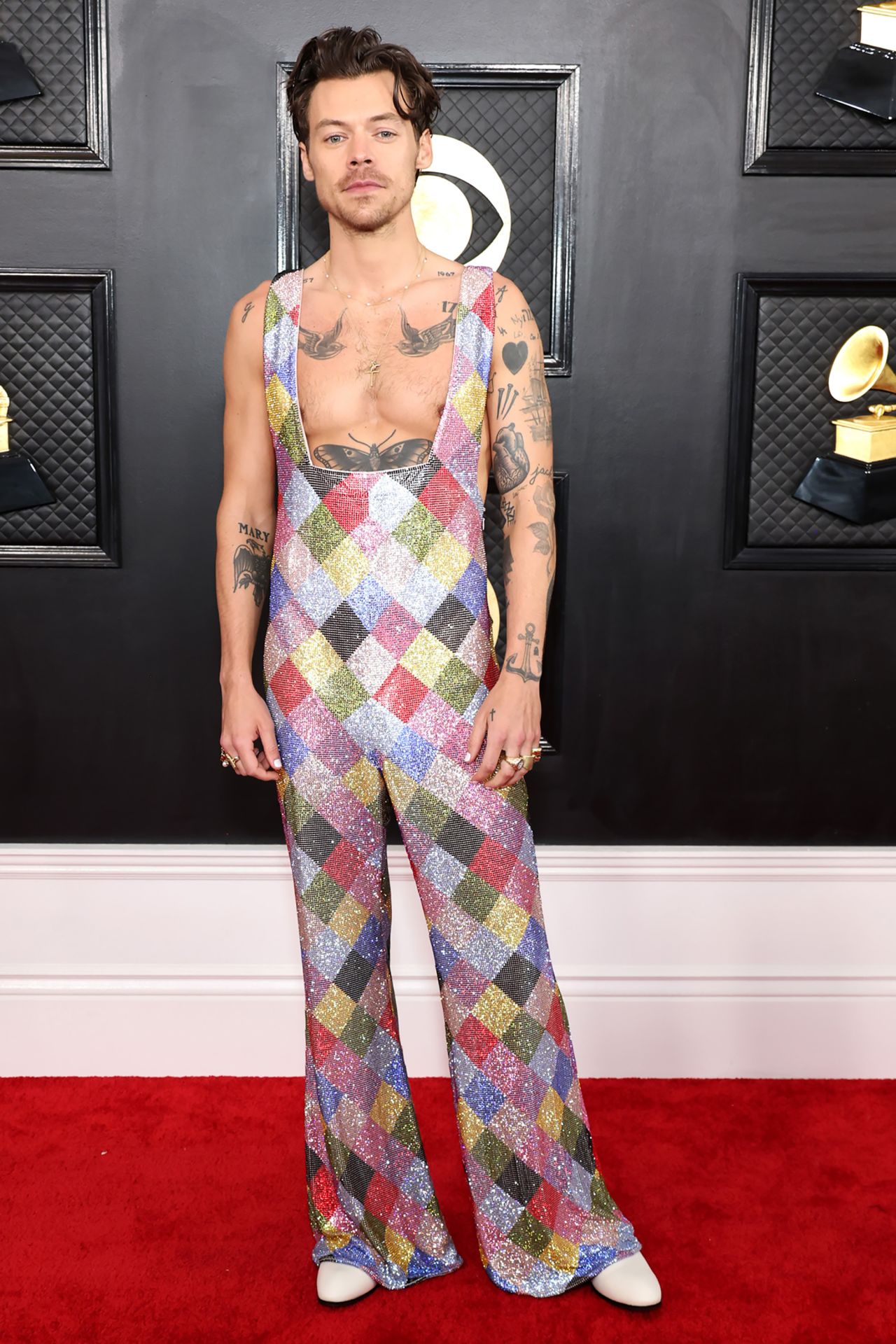 Harry Styles in a rainbow-colored harlequin jumpsuit by Egonlab and Swarovski.