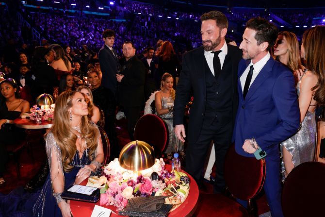 From left, Jennifer Lopez, Ben Affleck and Adrien Brody attend the show. <a href="index.php?page=&url=https%3A%2F%2Fwww.cnn.com%2Fentertainment%2Flive-news%2Fgrammy-awards-2023%2Fh_941ccab490a19cd7fd10ba5cab9449e7" target="_blank">See more photos from behind the scenes</a>.