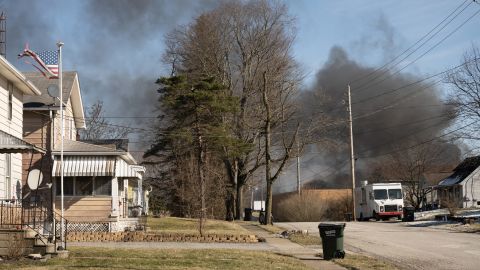 Smoke from a derailed cargo train lingers Saturday over a neighborhood in East Palestine, Ohio. 