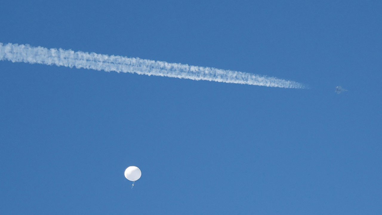 A jet flies by a suspected Chinese spy balloon as it floats off the coast in Surfside Beach, South Carolina, U.S. February 4, 2023.