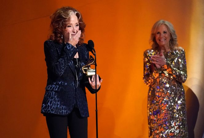 A surprised Bonnie Raitt <a href="index.php?page=&url=https%3A%2F%2Fwww.cnn.com%2Fentertainment%2Flive-news%2Fgrammy-awards-2023%2Fh_1ad0e0cc75898271bf691e7e530a4dc5" target="_blank">accepts the Grammy for song of the year</a> as she is applauded by first lady Jill Biden, who presented the award.