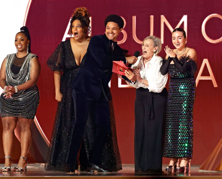 Host Trevor Noah holds the mic for a fan who read Styles's win for album of the year.