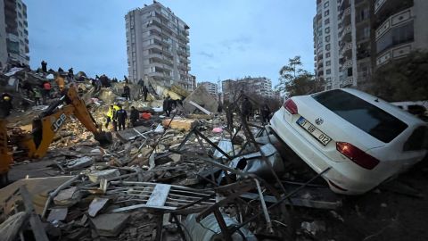 A destroyed apartment and damaged vehicle in Yurt neighborhood of Cukurova district after the earthquake in Adana, Turkey.