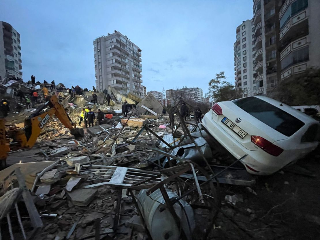 A destroyed apartment and damaged vehicle in Yurt neighborhood of Cukurova district after the earthquake in Adana, Turkey.
