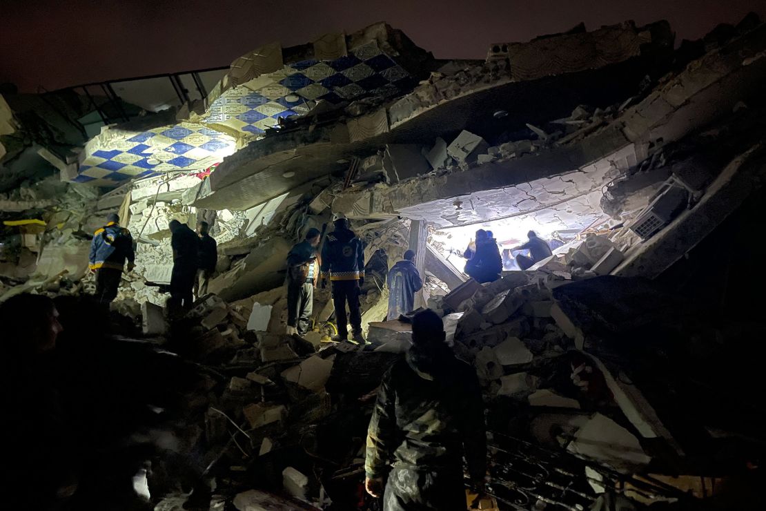 Syrian rescuers (White Helmets) and civilians search for victims and survivors amid the rubble of a collapsed building, in the rebel-held northern countryside of Syria's Idlib province on the border with Turkey, early on Monday.