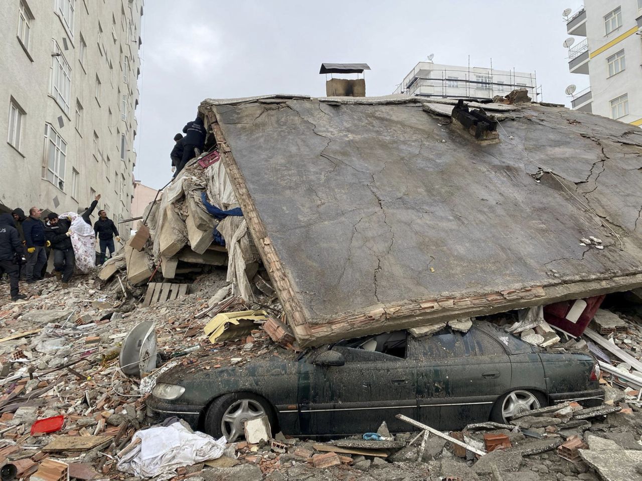 People work through the rubble of a collapsed building in Diyarbakir.