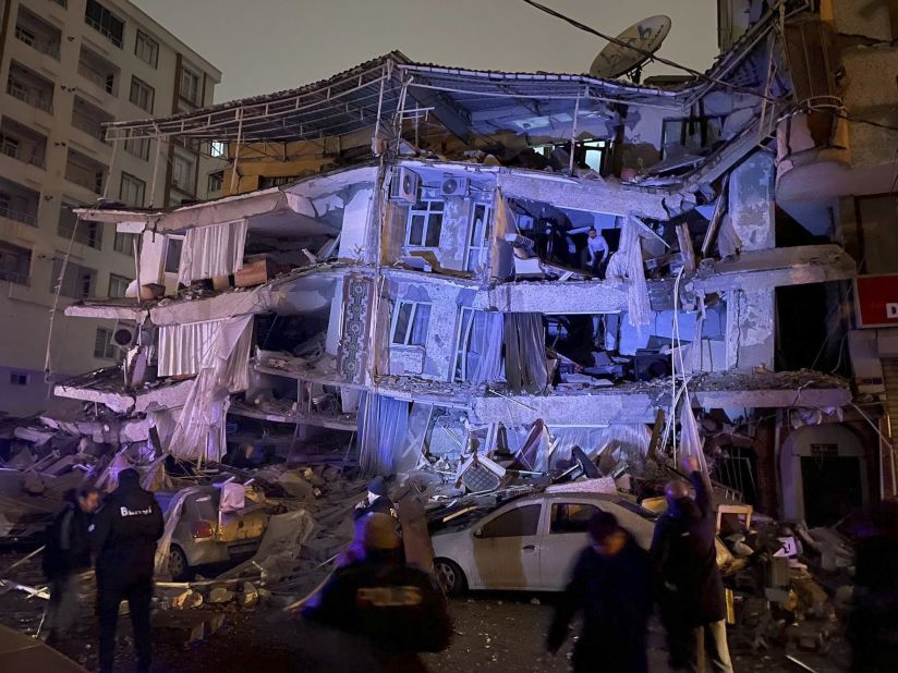 People search a destroyed building in Diyarbakir.