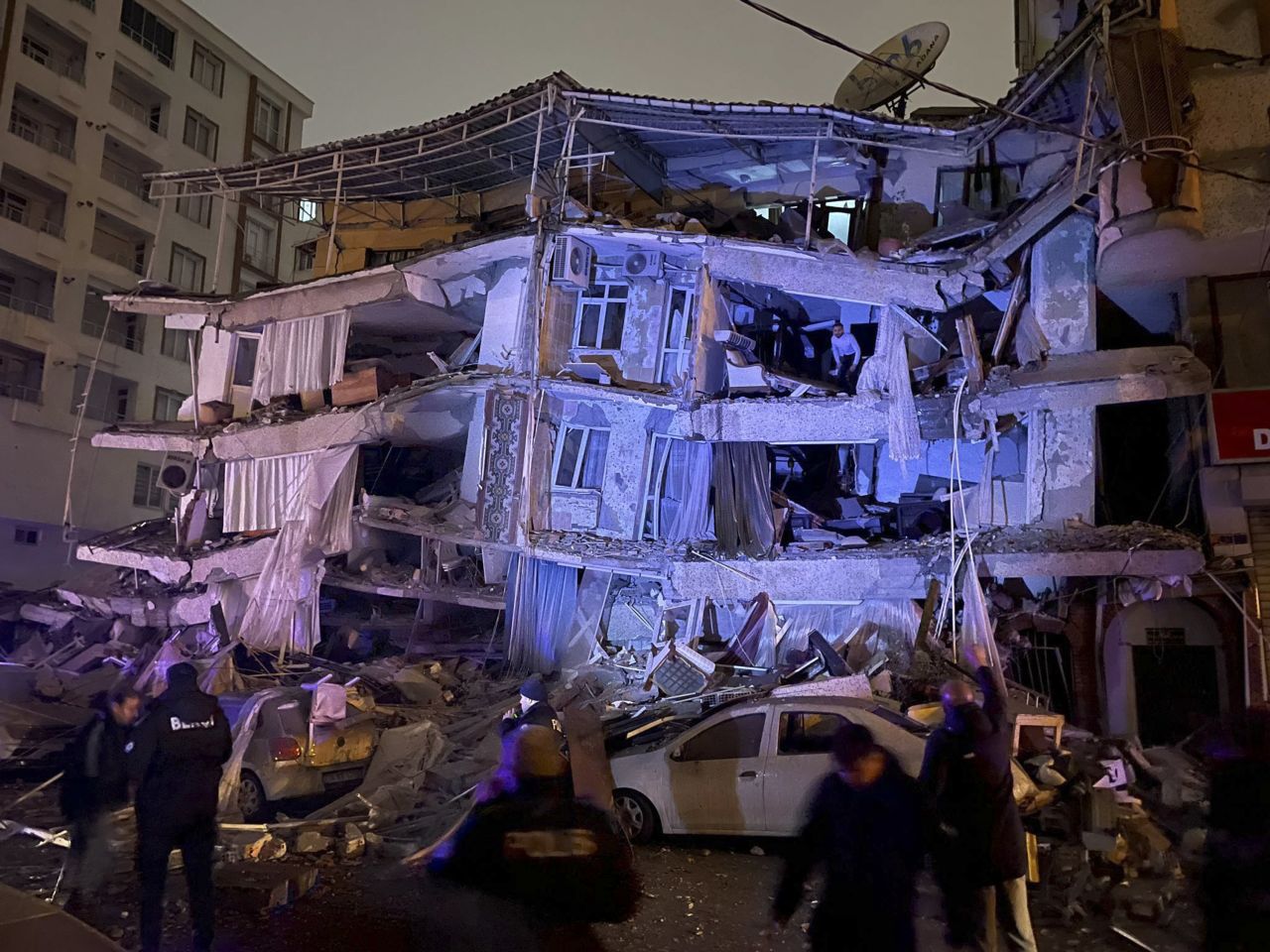 People search a destroyed building in Diyarbakir.