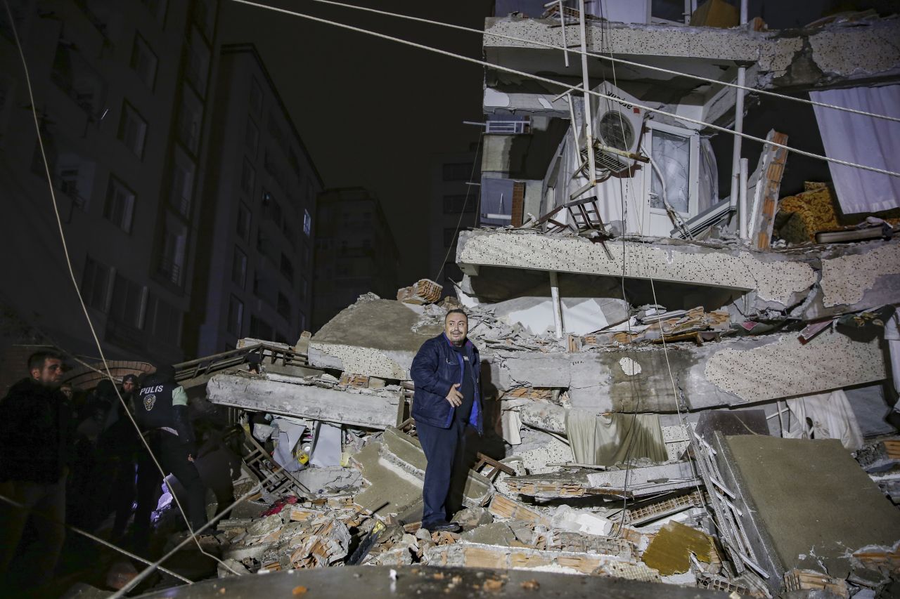 People search through rubble at a destroyed building in Diyarbakir.