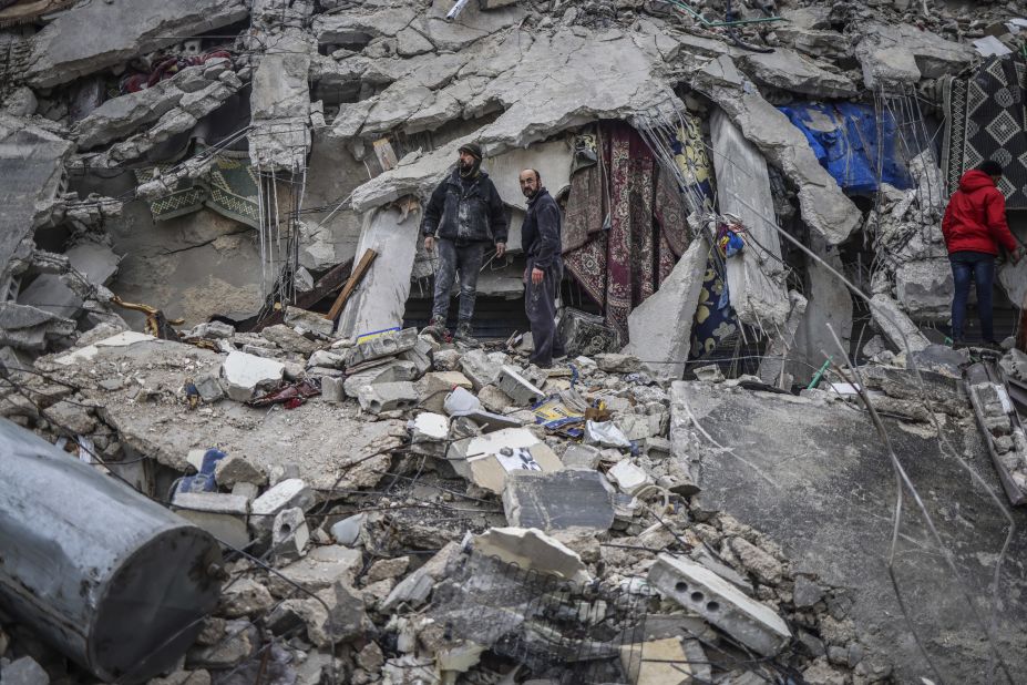 Civilians and members of the Syria Civil Defense try to save people trapped beneath a destroyed building in Idlib.