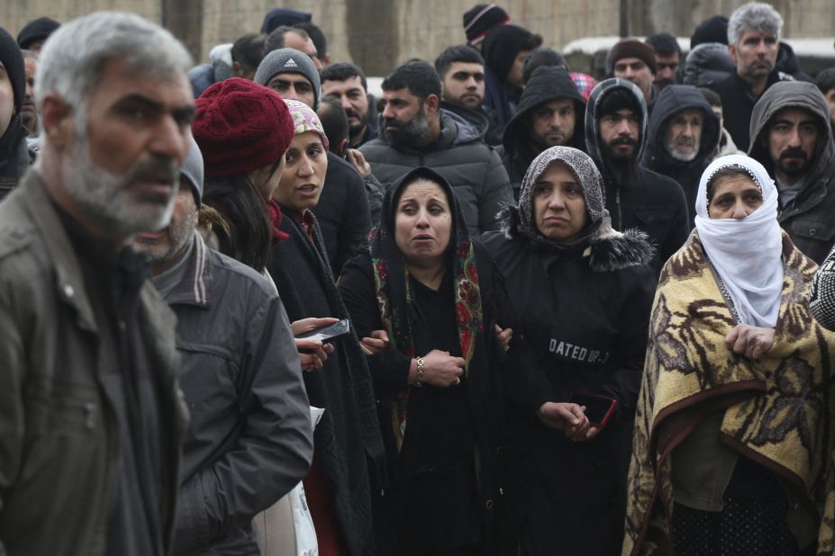 People wait as rescue operations take place in Diyarbakir on February 6.