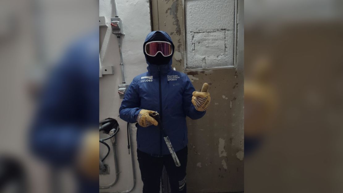 Meteorologist and weather observer for Mount Washington Observatory, Alexis George, prepares to go out on the deck to take wind and temperature measurements during extreme weather conditions Friday, February 3, 2023.