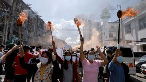 A group of women hold torches as they protest against the military coup in Yangon, Myanmar July 14, 2021.