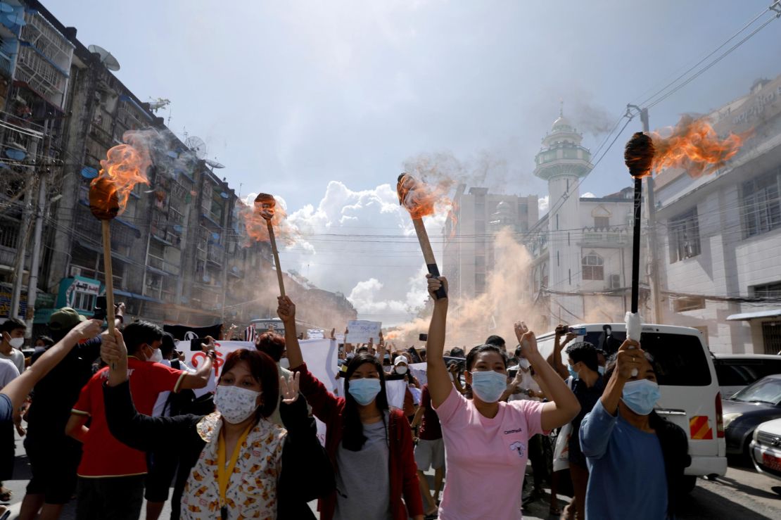 A group of women hold torches as they protest against the military coup in Yangon, Myanmar July 14, 2021.