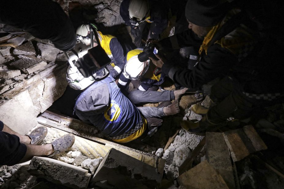 Members of the Syria Civil Defense, aka the White Helmets, retrieve an injured man from the rubble of a collapsed building in Azaz, Syria.