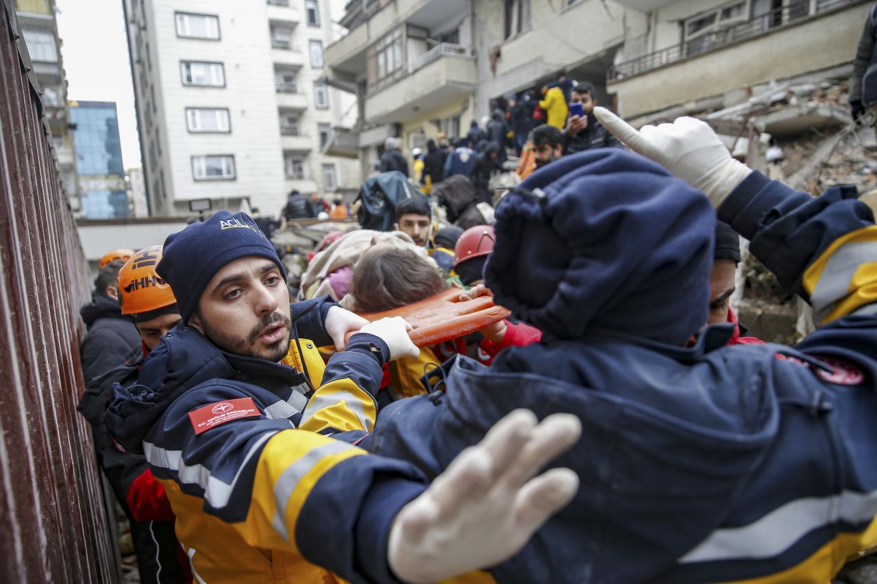 Emergency workers rescue a child from a collapsed building in Diyarbakir.