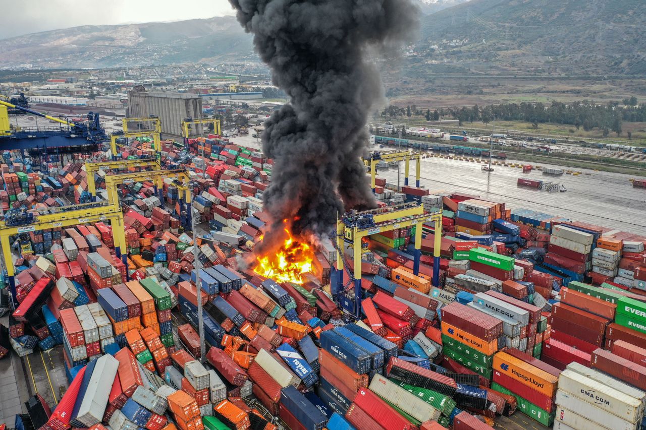 A fire burns near overturned containers in Hatay.