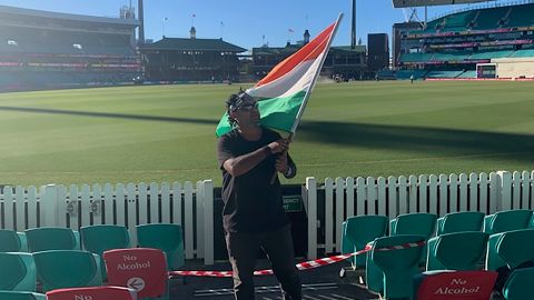 Krishna Kumar waves the Indian flag during the test match between Australia and India. 