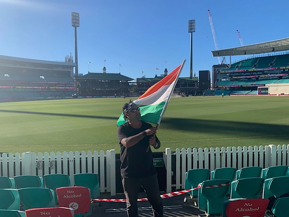 Krishna Kumar waves the Indian flag during the test match between Australia and India. 