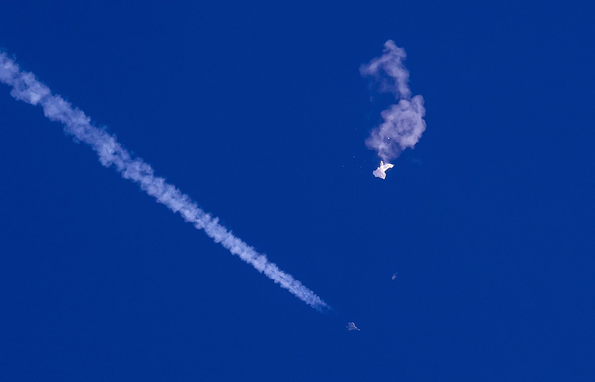 The remnants of a suspected Chinese surveillance balloon drift above the Atlantic Ocean after US fighter jets shot the balloon down.