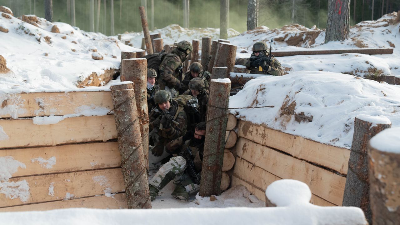 French mountain commandos fire upon "enemy" troops as they storm a trench in a NATO exercise in Estonia.  
 