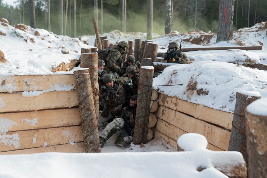 French mountain commandos fire upon "enemy" troops as they storm a trench in a NATO exercise in Estonia.  
 