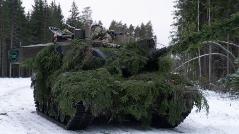 A British tank commander gives orders to the crew of a Challenger 2 tank during a NATO exercise in Estonia.