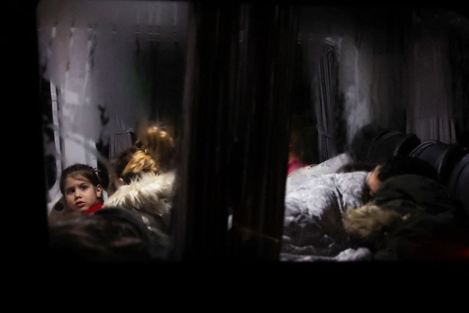 A child looks out from a bus where people were sleeping in Antakya, Turkey, on February 6.