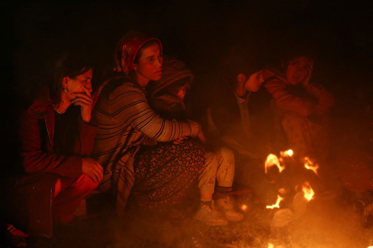 People gather around a bonfire in Kahramanmaraş, Turkey.