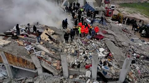 Rescuers search through rubble of collapsed buildings following an earthquake, in the rebel-held town of Sarmada, Syria February 6, 2023. 