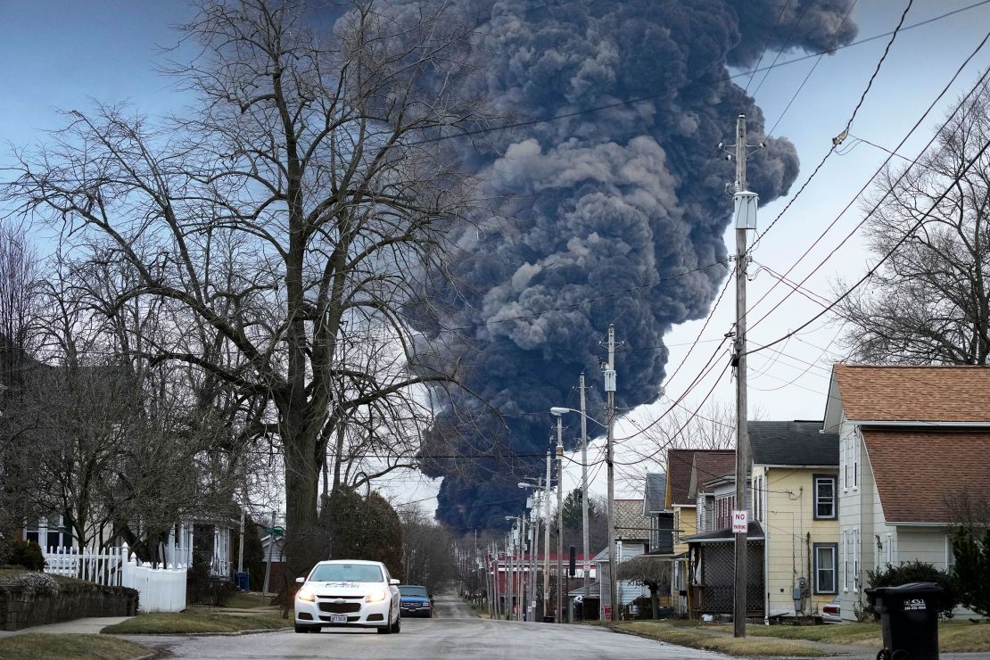 A black plume rises over East Palestine, Ohio, as a result of a controlled detonation of a portion of the derailed Norfolk and Southern trains February 6, 2023. 