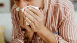 Young man with flu like symptoms