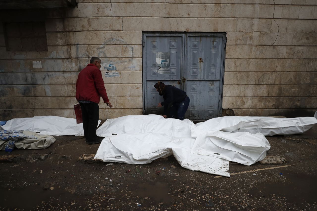 People try to identify the bodies of earthquake victims outside a hospital in Aleppo, Syria, on Monday.