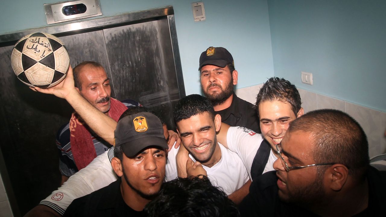 Palestinian football player Mahmoud Sarsak, who staged a hunger strike of nearly three months while in Israeli jail, is surrounded by relatives and supporters at the Al-Shifa hospital in Gaza City on July 10, 2012 upon his release from prison.