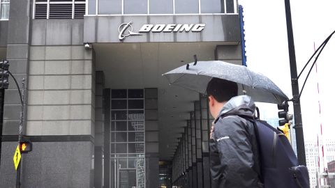 A pedestrian walks by The Boeing Company headquarters on May 05, 2022 in Chicago, Illinois. The Boeing Company said it would be moving its headquarters from Chicago, where it has been located since 2001, to Northern Virginia.   