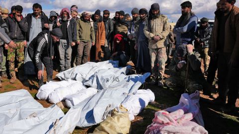 Syrians mourn over the bodies of a family and close neighbours who were killed in the village of Hajji Iskandar, on February 7, 2023. 