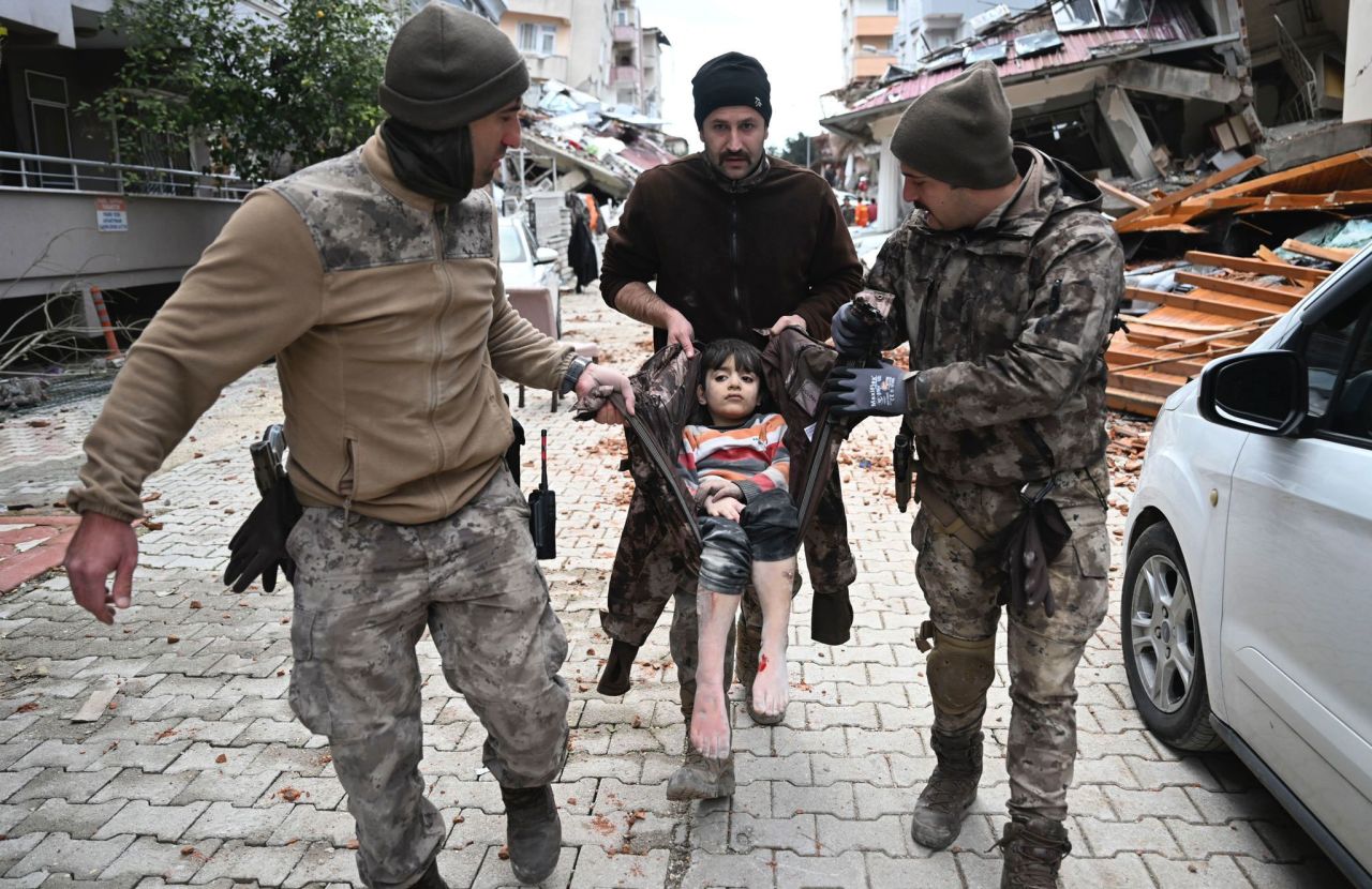 Police carry a child rescued from rubble in Hatay on February 7.