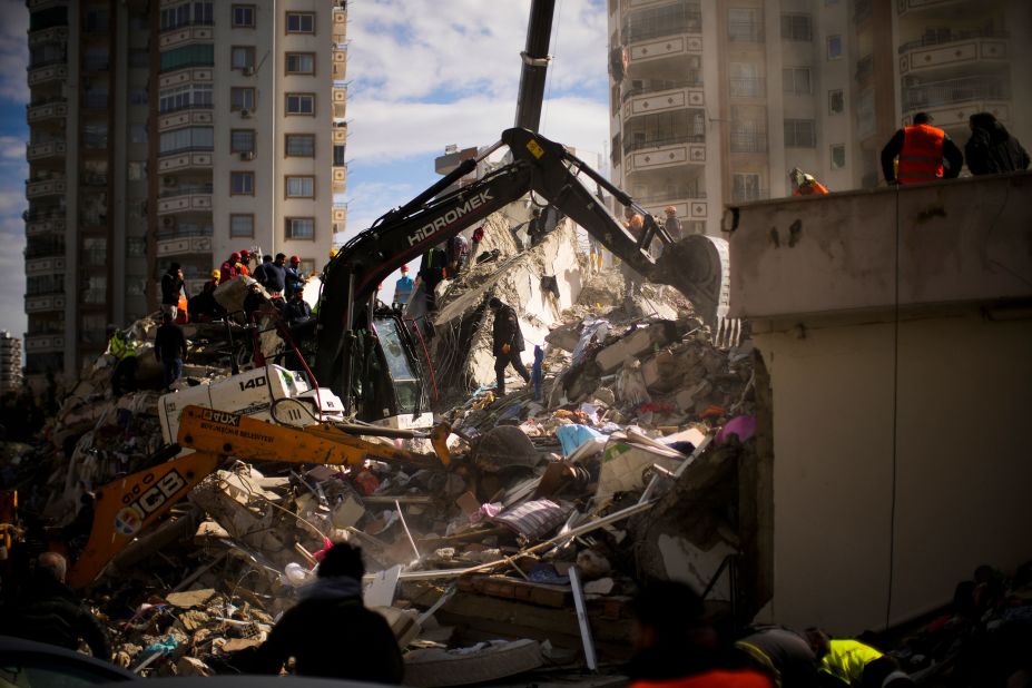 Emergency workers search for people in a destroyed building in Adana, Turkey, on February 7.
