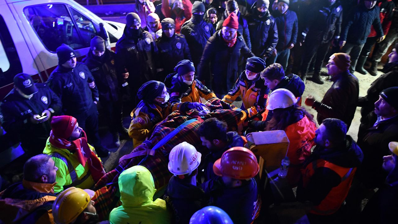 A family is rescued from the rubble of a collapsed building after 40 hours of search and rescue efforts on Tuesday in Turkey.