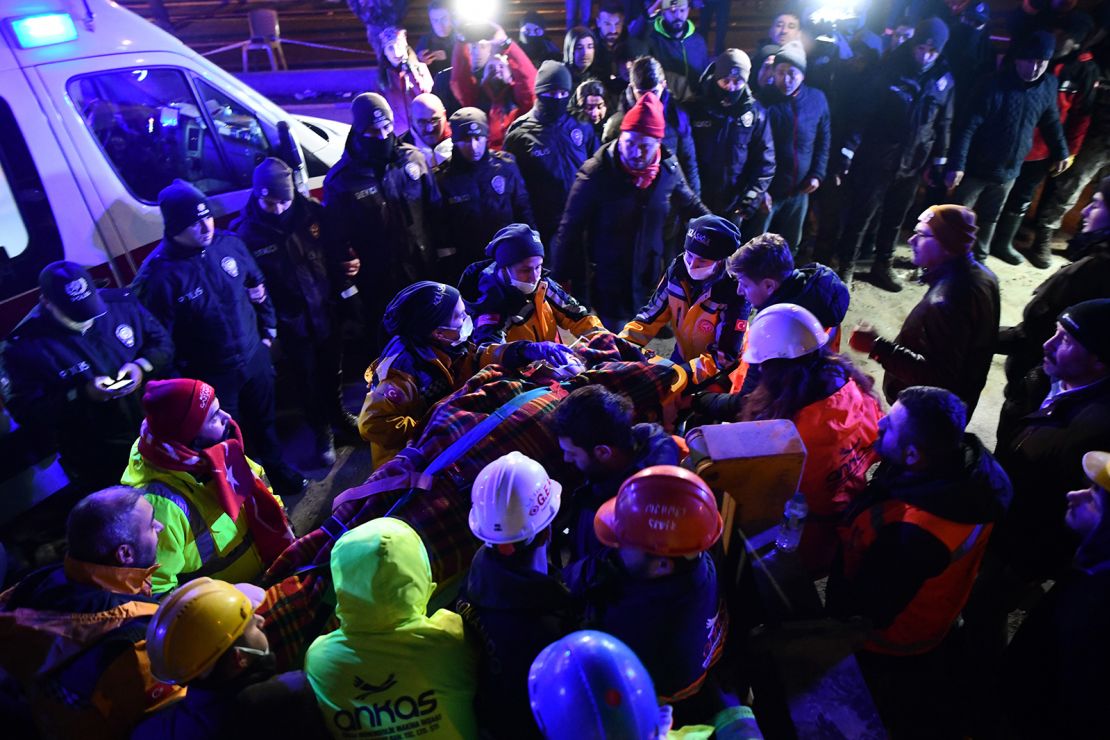 A family is rescued from the rubble of a collapsed building after 40 hours of search and rescue efforts on Tuesday in Turkey.