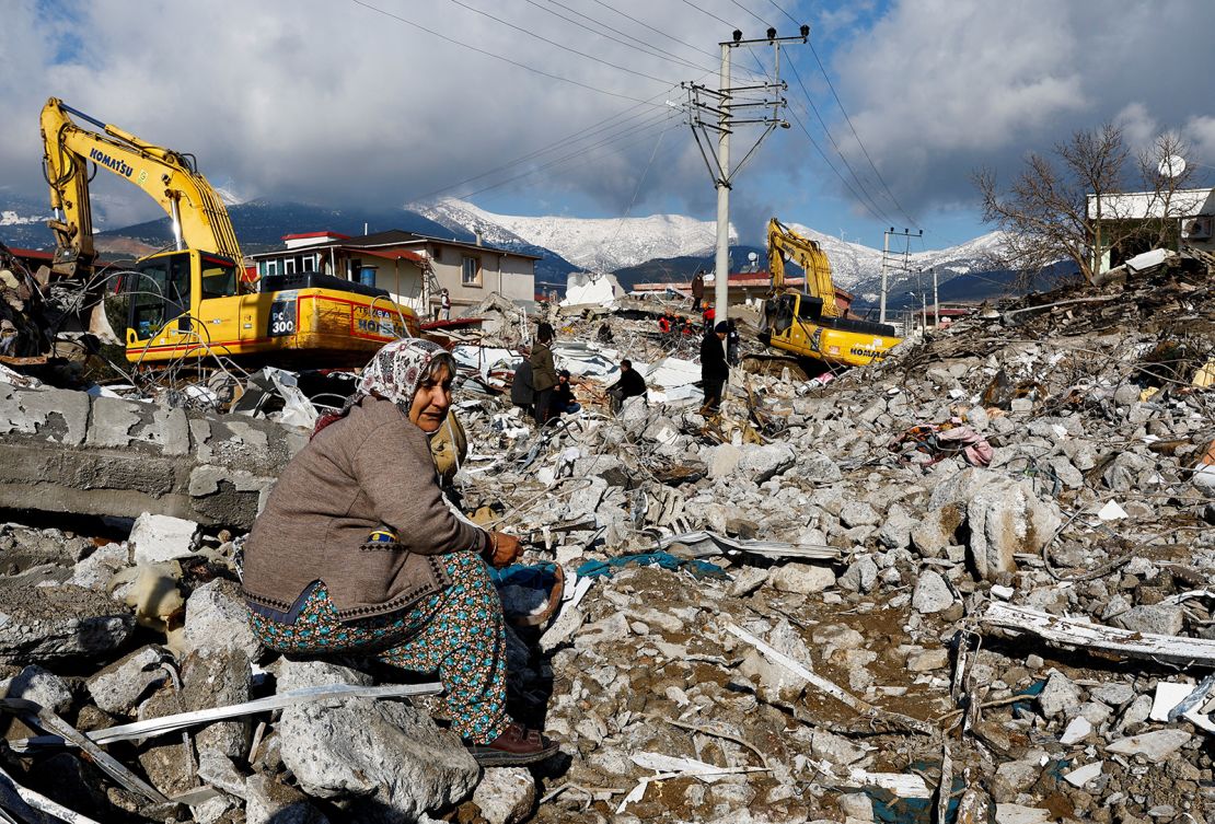 A woman sits amid the rubble and damage in Gaziantep on Tuesday.