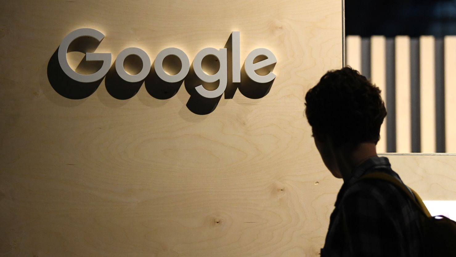 A woman passes the logo from the web search engine provider Google during the digital society festival 're:publica', at the Arena Berlin in Berlin, Germany June 9, 2022.