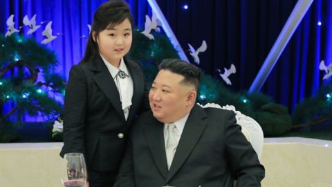 KIm Jong Un is pictured with a girl believed to be his daughter at a military banquet on Tuesday.