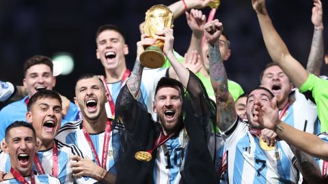 Lionel Messi of Argentina lifts the Qatar FIFA World Cup Winner's Trophy on December 18, 2022. 