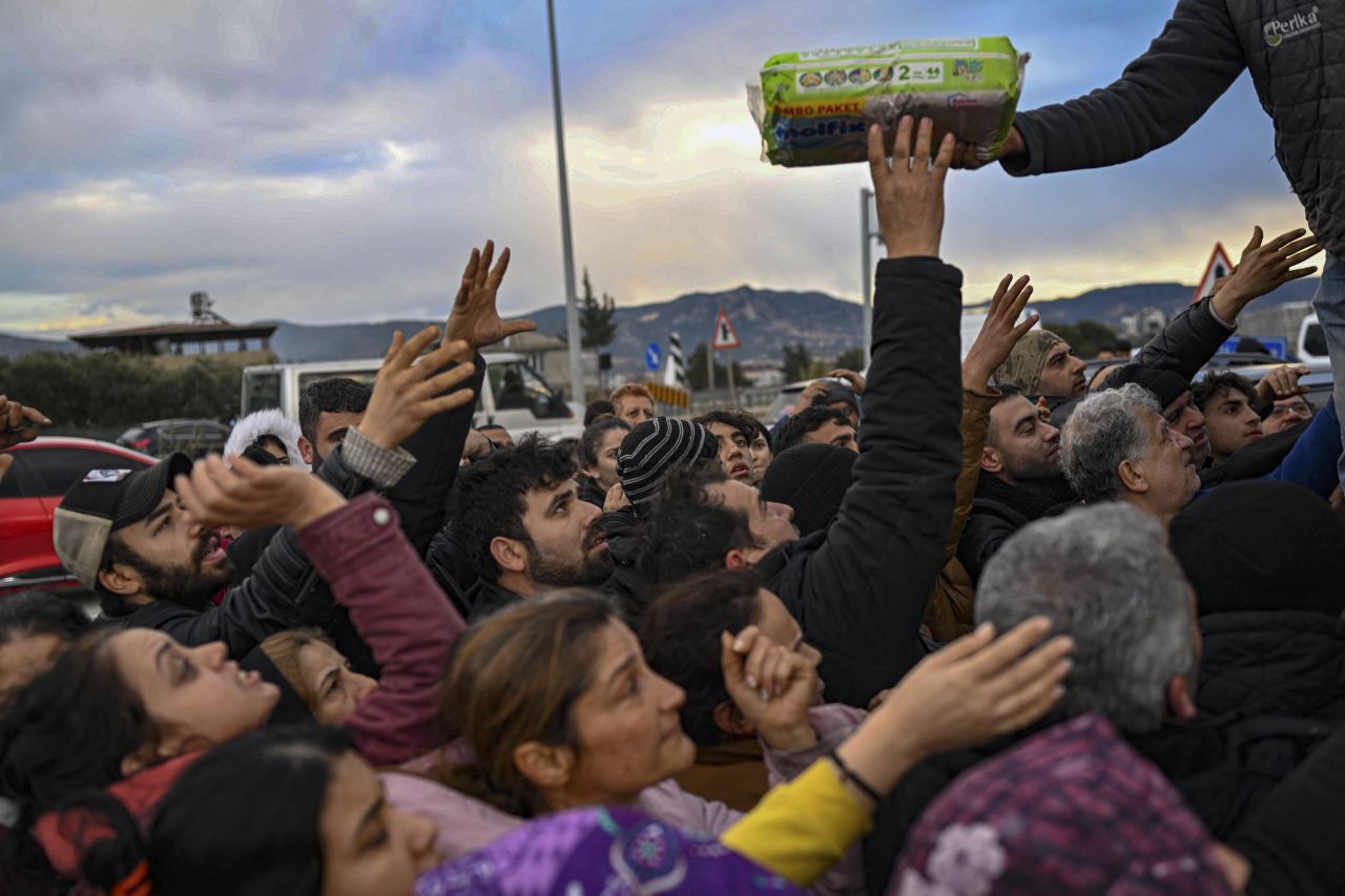 Earthquake survivors gather to collect supplies at a diaper distribution in Hatay on Tuesday, February 7.